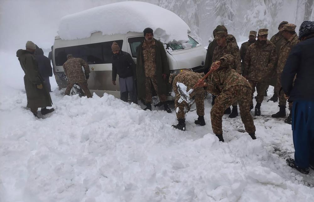 In this photo provided by the Inter Services Public Relations, army troops take part in a rescue operation in a heavy snowfall-hit area in Murree, some 28 miles (45 kilometers) north of the capital of Islamabad, Pakistan, Saturday, Jan. 8, 2022. (AP)
