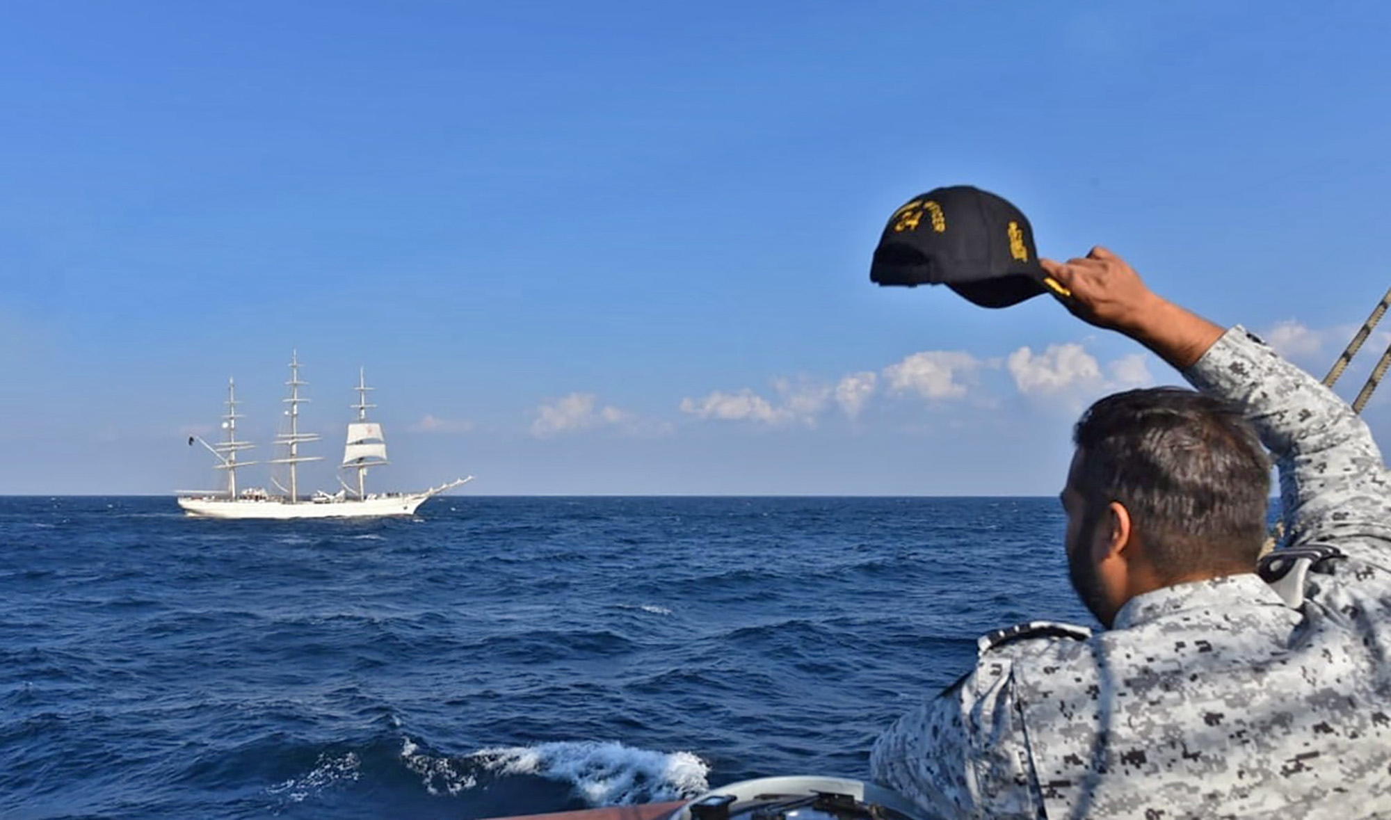 This photograph shared by the Pakistan Navy on January 9, 2022 shows a naval officer waving at a Pakistan Navy ship. (Photo courtesy: @PakistanNavy/Facebook)
