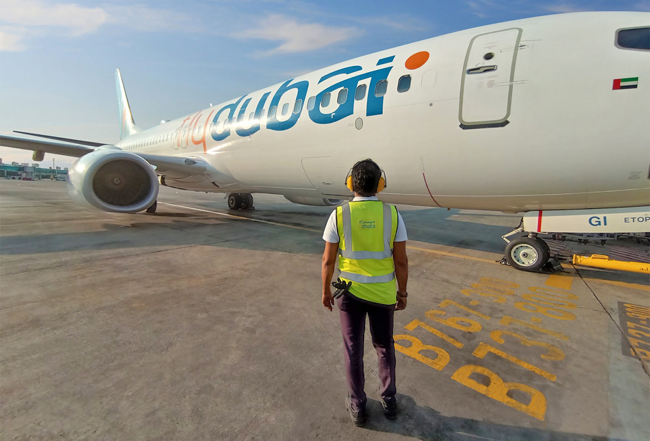 This undated picture shows a man standing in front of the flydubai aircraft, a customer of United Arab Emirates-based Gerry’s dnata, which operates at four airports in Pakistan. (Photo courtesy: dnta)