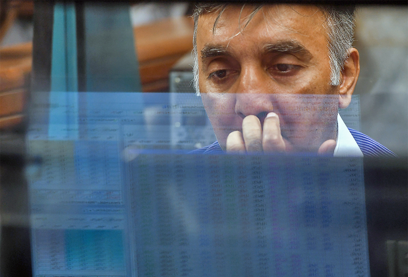 A Pakistani stockbroker looks at share prices on a computer monitor during a trading session in Karachi, Pakistan, on May 8, 2019. (AFP/File)