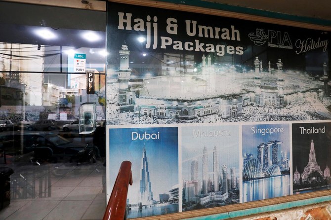 A sign promotes airline's Haj and Umrah packages outside a ticketing office, as the spread of the coronavirus disease (COVID-19) continues, in Karachi, Pakistan July 6, 2020. (REUTERS)