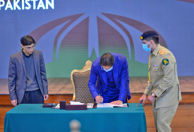 Pakistan Prime Minister Imran Khan, second left, signs country’s first ever national security policy in Islamabad, Pakistan, on January 14, 2021. (Prime Minister Office)