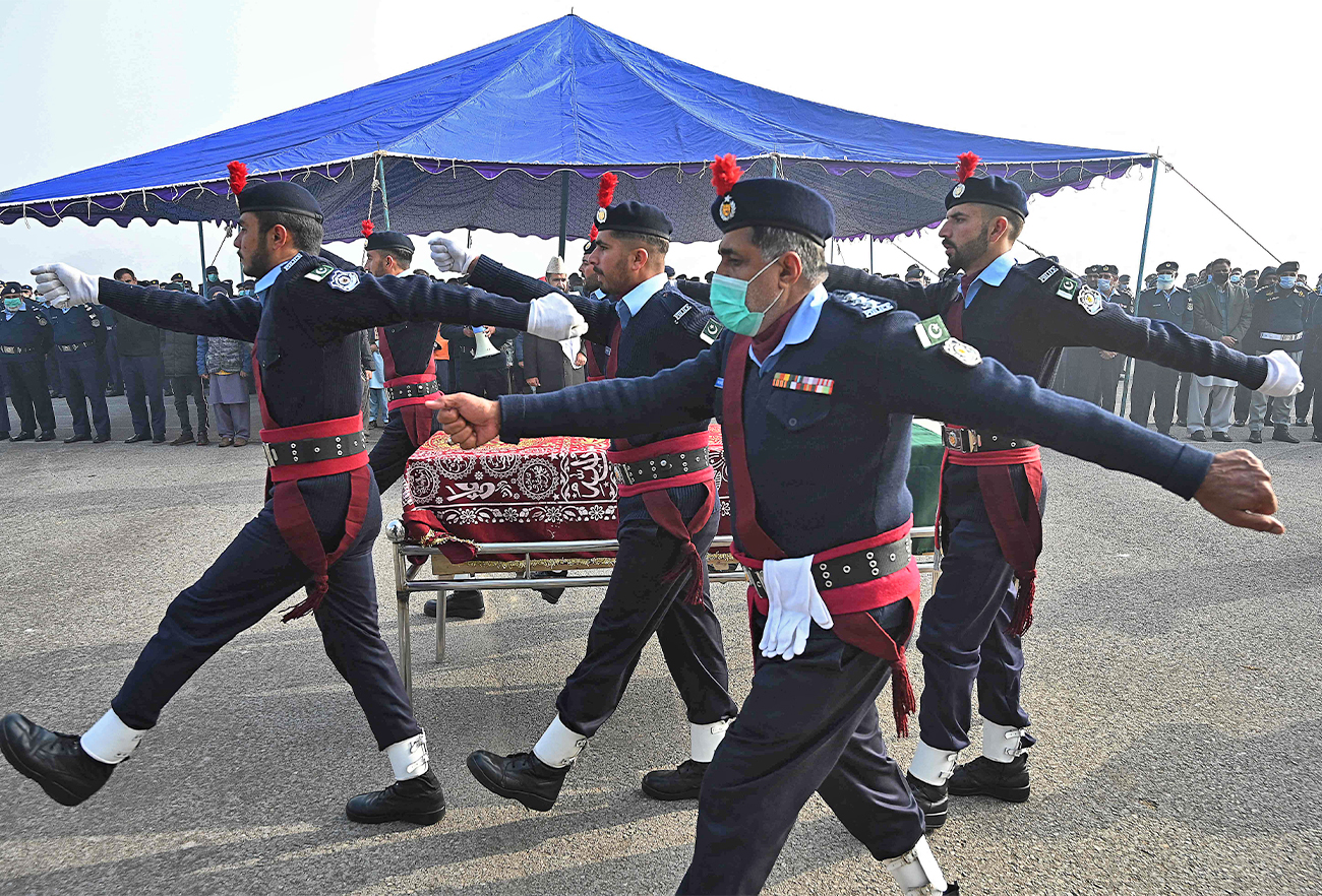 Policemen march past the coffin of a police officer who was killed in an overnight gunmen attack during the funeral ceremony in Islamabad, Pakistan, on January 18, 2022. (AFP)