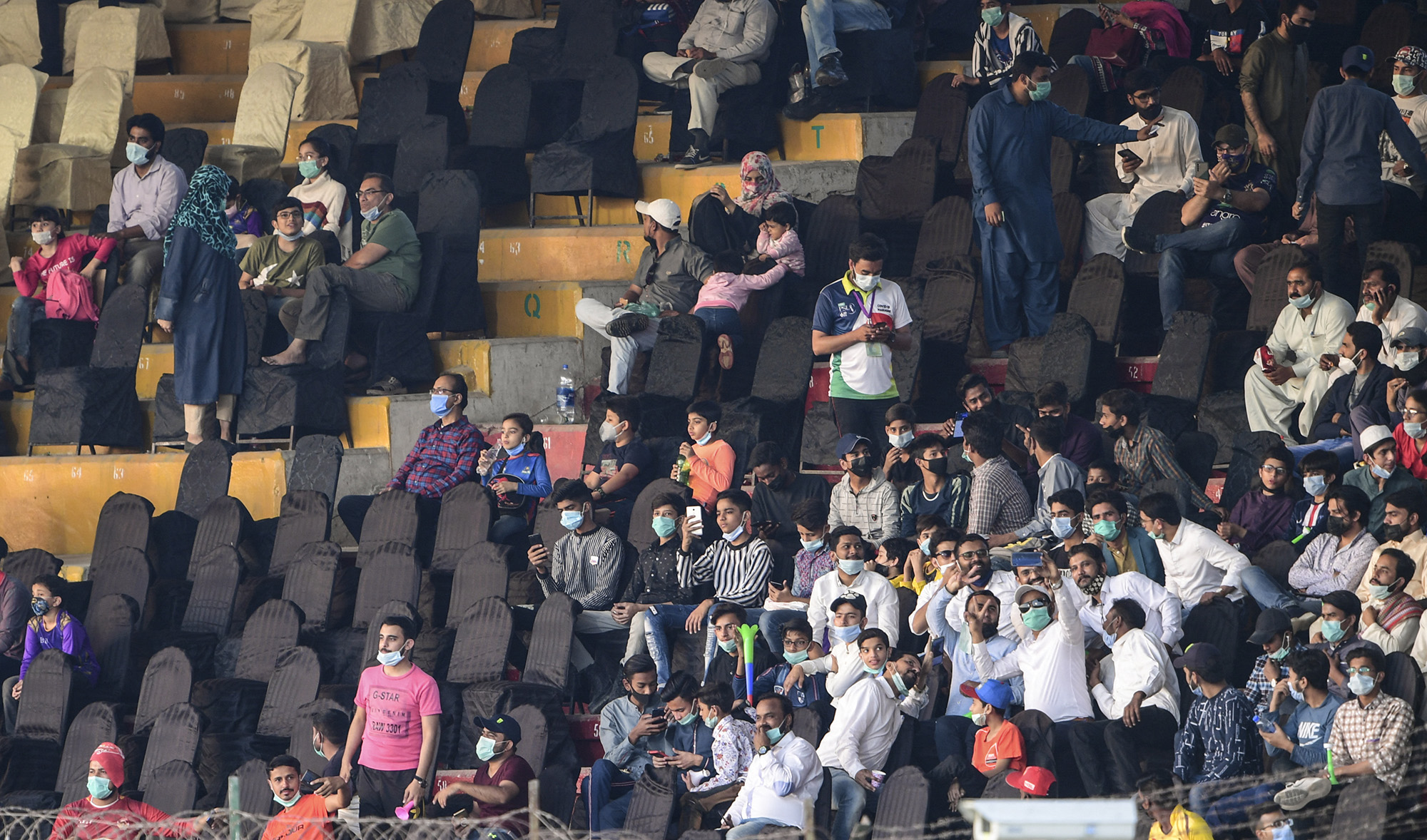 People watch the Pakistan Super League (PSL) T20 cricket match between Islamabad United and Quetta Gladiators at the National Stadium in Karachi on March 2, 2021. (AFP/File)