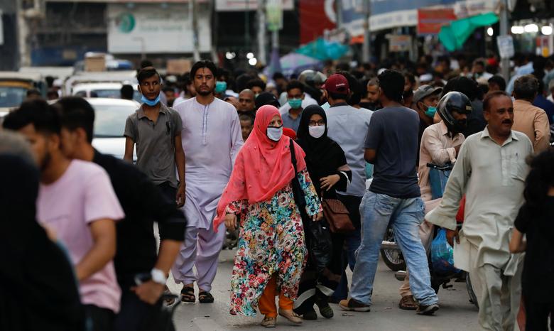 Women wearing protective face masks walk amid the rush of people along a road as the outbreak of the coronavirus disease (COVID-19) continues, in Karachi, Pakistan July 20, 2020. (REUTERS/FILE)