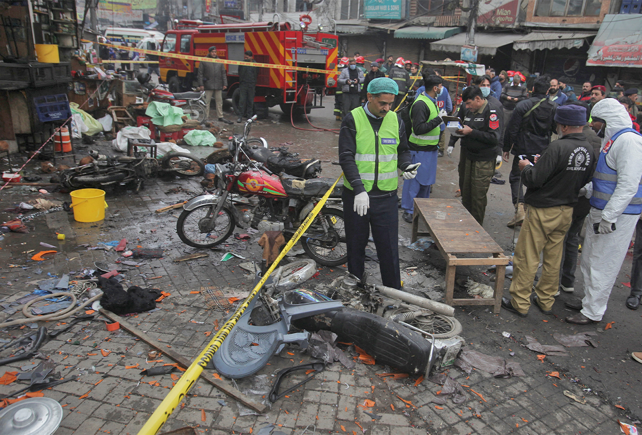 Members of crime scene unit and a bomb disposal team gather after a blast in a market, in Lahore, Pakistan, on January 20, 2022. (REUTERS)