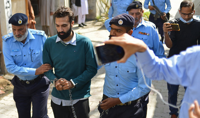Policemen escort Zahir Jaffer (2L), a Pakistani-American man who went on trial accused of raping and beheading his girlfriend, the daughter of a former ambassador, after his court hearing in Islamabad on October 20, 2021. (AFP/File)