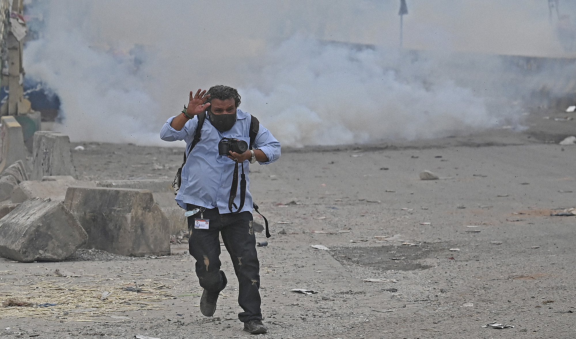 A photo-journalist reacts to the riots in Islamabad, Pakistan, on April 13, 2021. (AFP/File)