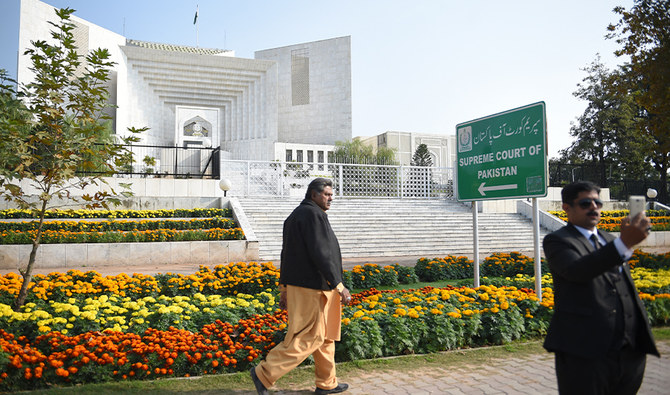 A Pakistani lawyer (R) uses his mobile phone in front of the Supreme Court building in Islamabad on November 28, 2019. (AFP/FILE)