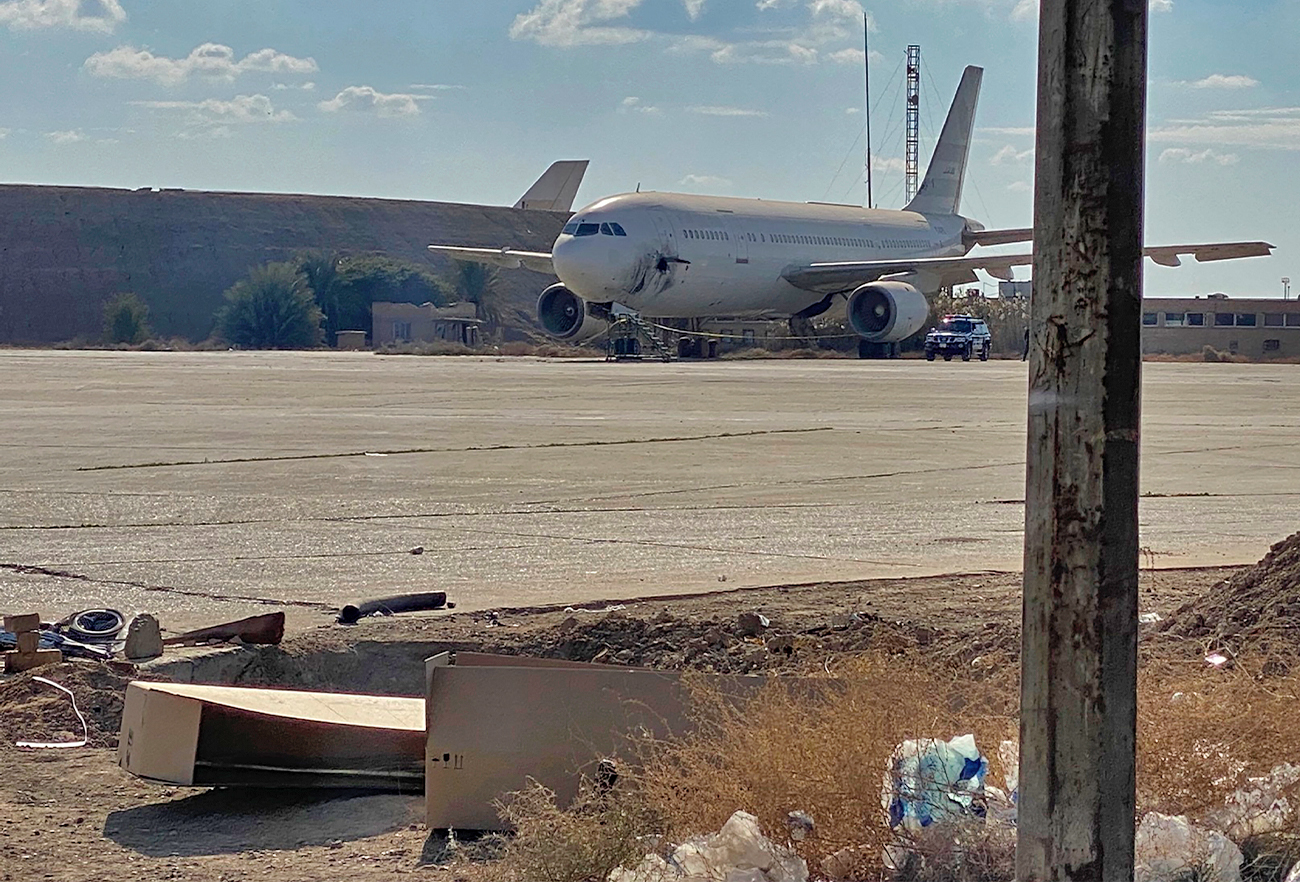 A damaged aircraft sits on the tarmac of Baghdad airport, after a rocket attack in Baghdad, Iraq, on January 28, 2022. (AP)