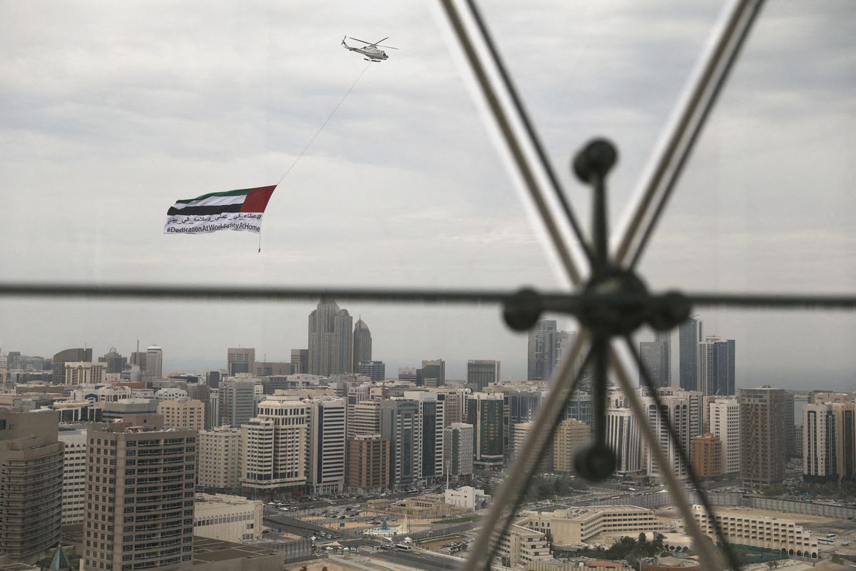 A helicopter flies over the downtown skyline of Abu Dhabi, United Arab Emirates, on April 20, 2020. (REUTERS/File)