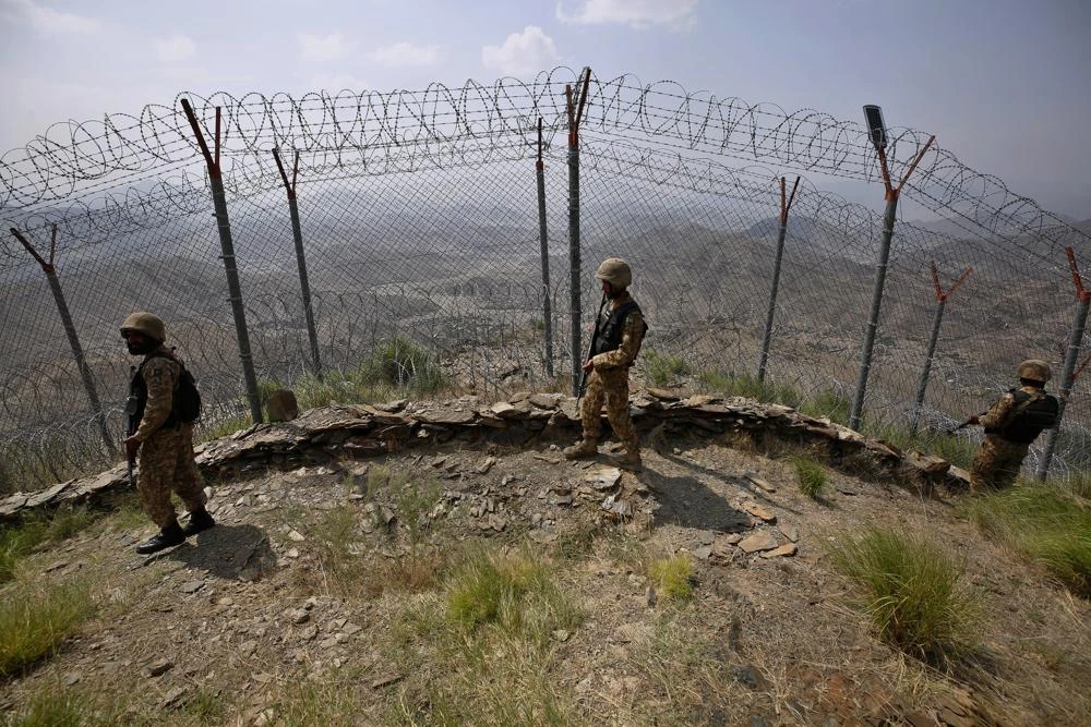 Pakistan Army troops patrol along the fence on the Pakistan Afghanistan border at Big Ben hilltop post in Khyber district, Pakistan, Aug. 3, 2021. (AP)