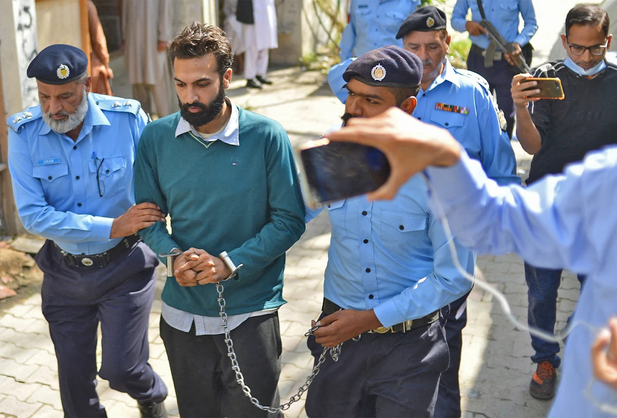 Policemen escort Zahir Jaffer (2L), a Pakistani-American man who went on trial accused of raping and beheading his girlfriend, the daughter of a former ambassador, after his court hearing in Islamabad, Pakistan, on October 20, 2021. (AFP/File)