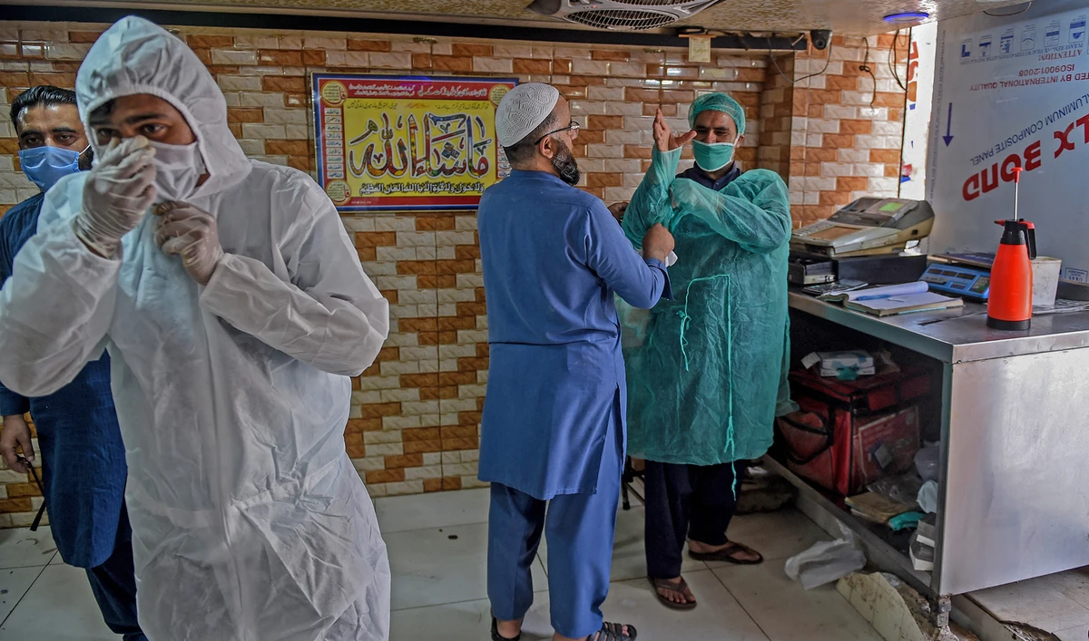 Employees wear protective gear at a restaurant open for takeaway and delivery services during a government-imposed nationwide lockdown as a preventive measure against the COVID-19, in Karachi on April 18, 2020. (AFP/File)