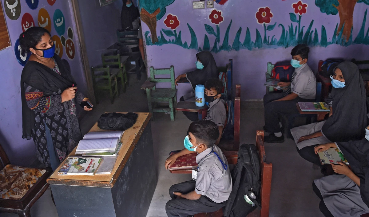 Students wearing facemasks attend a class at a school in Karachi, Pakistan, on September 28, 2020. (AFP/File)