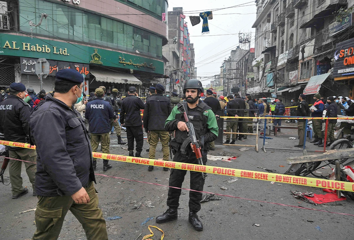 Security officials cordon off the site of a bomb blast that killed two people and wounded 22 others at a busy shopping district in Lahore, Pakistan, on January 20, 2022. (AFP)