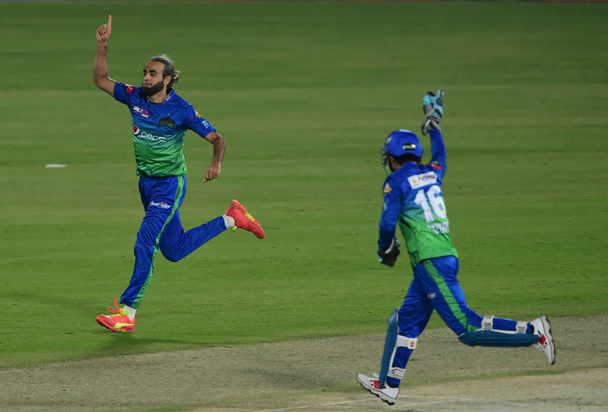 Multan Sultans' Imran Tahir (L) celebrates after taking the wicket of Karachi Kings' Sharjeel Khan (not pictured) during the Pakistan Super League T20 cricket match between Karachi Kings and Multan Sultans in Karachi on January 27, 2022. (AFP)