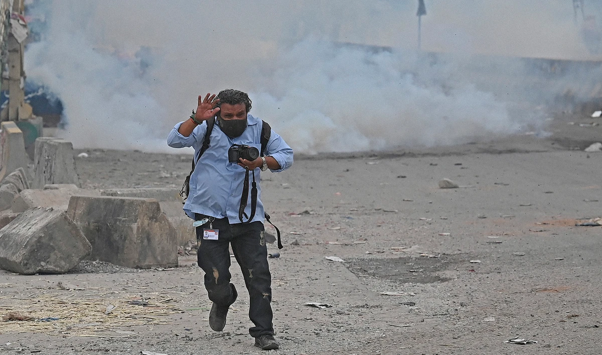 A photo-journalist reacts to the riots in Islamabad, Pakistan, on April 13, 2021. (AFP/File)