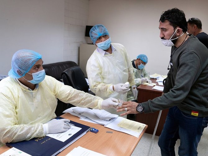 A man takes coronavirus clearance certificate from a doctor at a health clinic in Subhan, Kuwait, on March 9, 2020. (REUTERS/File)