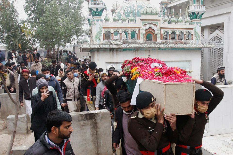 Army soldiers carry the coffin containing the body of Captain Bilal Khalil, who was killed along with others in an attack on a military base in Nushki, during his funeral in Faisalabad, Pakistan, February 4, 2022. (REUTERS)