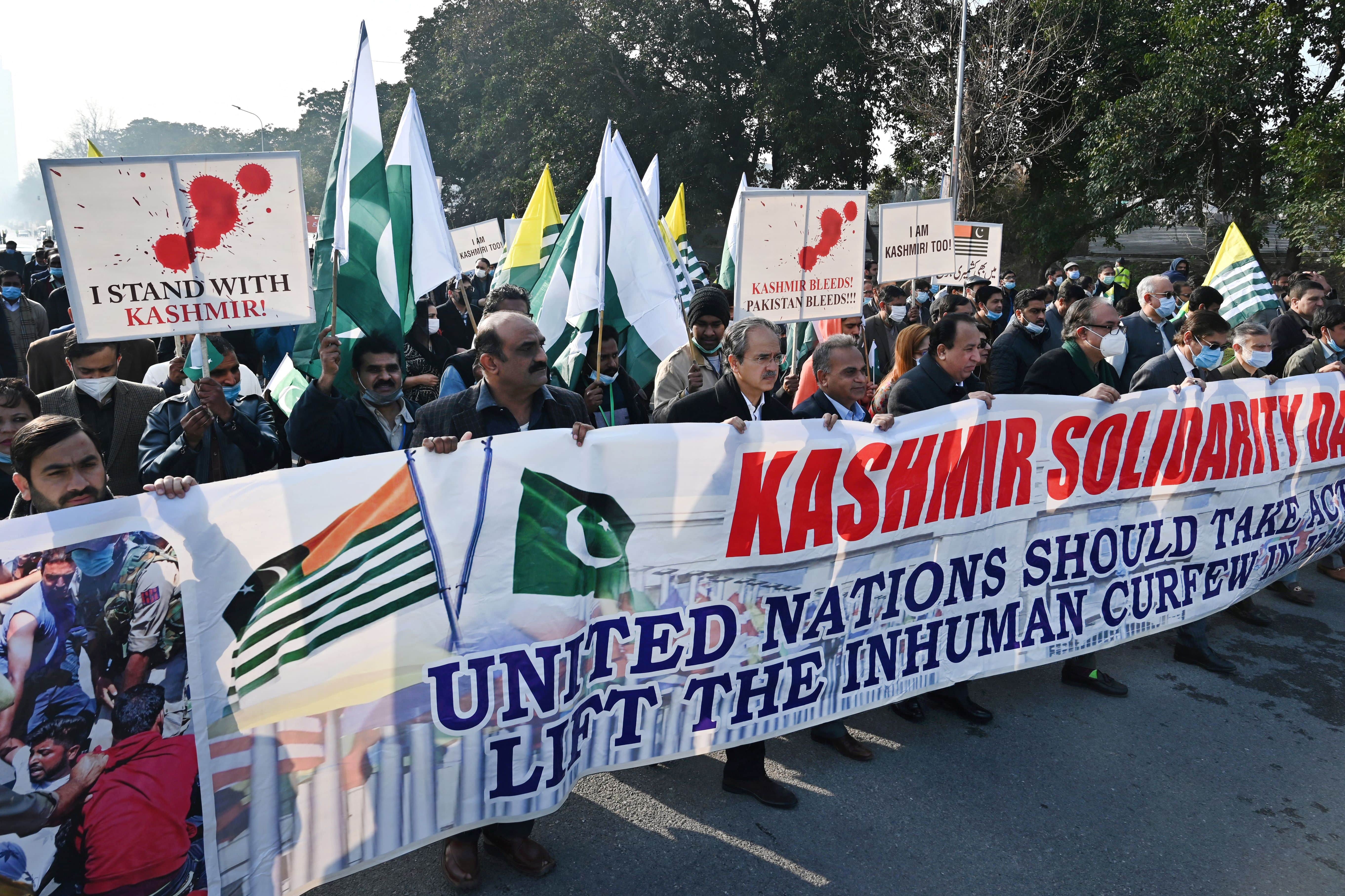 People carry a banner during a rally to mark Kashmir Solidarity Day in Islamabad on February 5, 2022. (AFP)