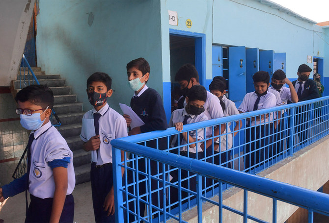 Students wait to receive a dose of the Pfizer vaccine against the coronavirus at a school in Karachi, Pakistan, on January 20, 2022. (AFP/File)