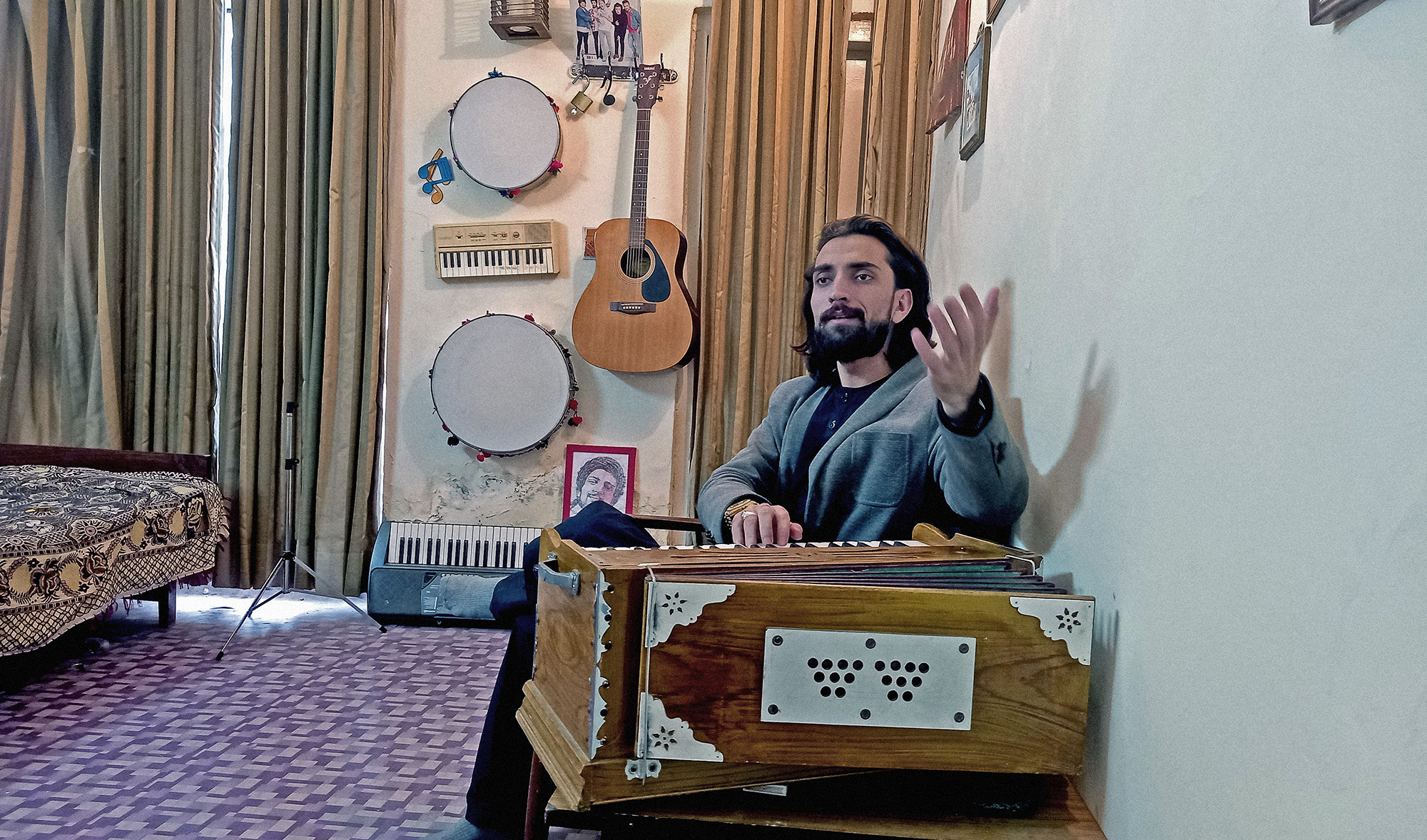 Maqsood Maseed, a professionally trained musician from the South Waziristan tribal district, plays the harmonium and sings at his residence in Islamabad, Pakistan, on February 3, 2022. (AN photo)