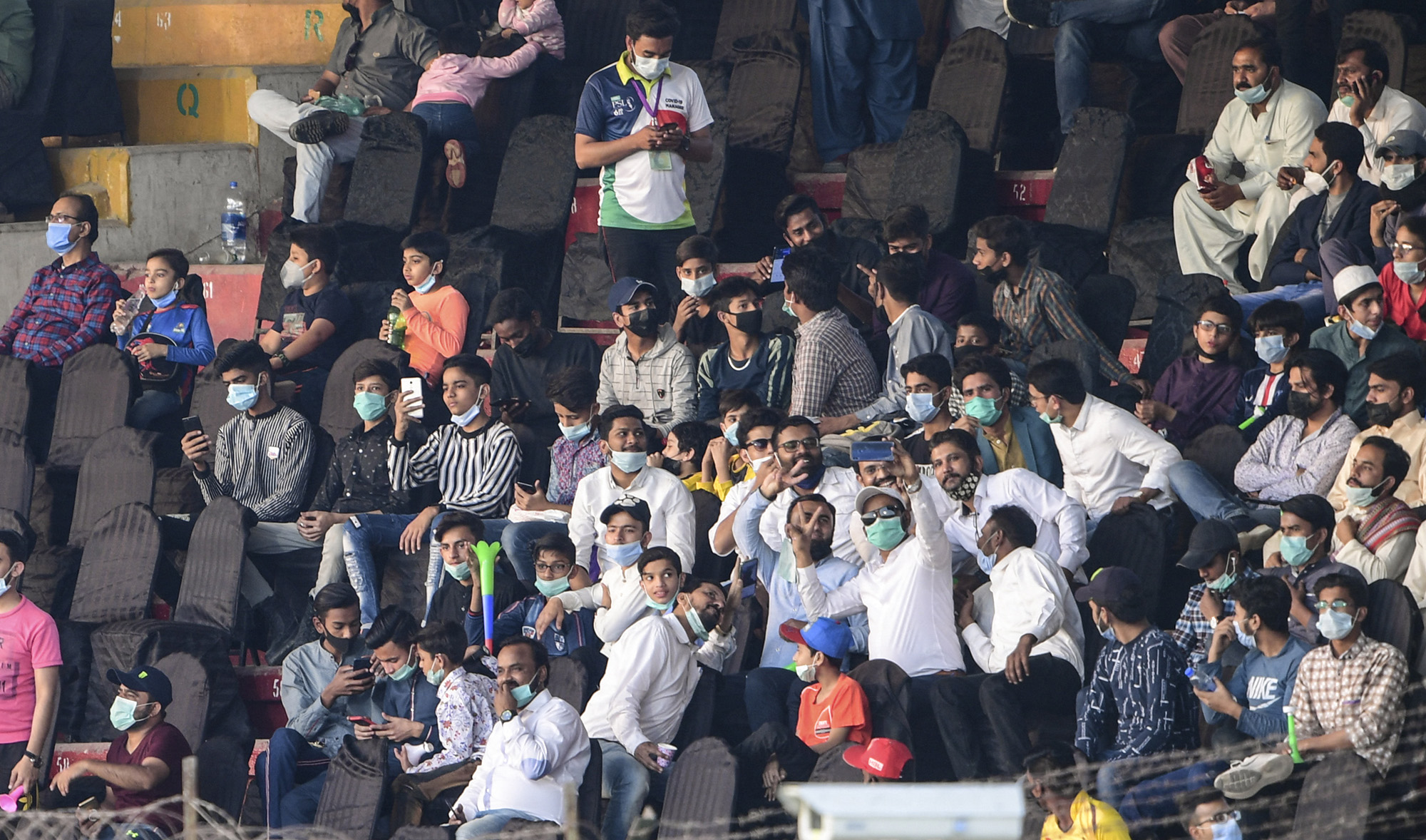 People watch the Pakistan Super League (PSL) T20 cricket match between Islamabad United and Quetta Gladiators at the National Stadium in Karachi on March 2, 2021. (AFP/File)