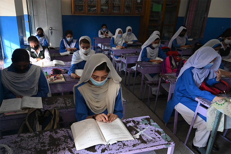 Students wearing facemasks attend a class at a school in Lahore on September 16, 2021. (AFP/FILE)