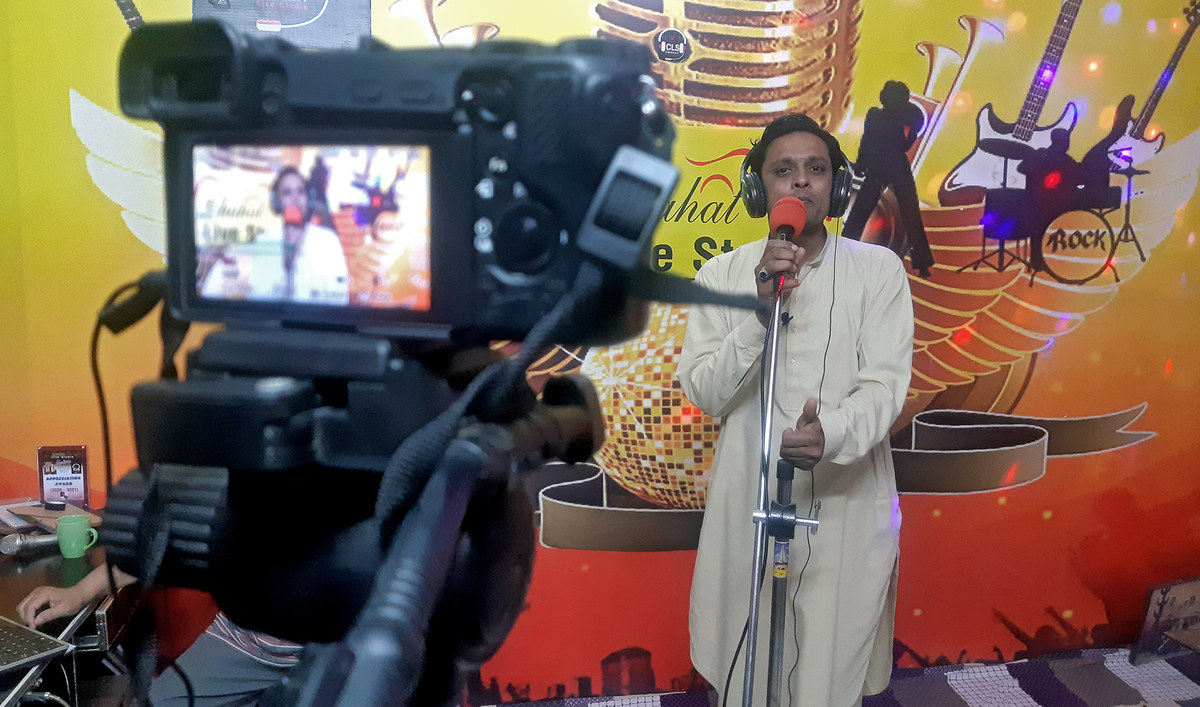 Muhammad Waseem, alias Waseem Lata, sings at a studio in Hyderabad, Pakistan, on February 07, 2022. (AN photo by Zulfiqar Kunbhar)