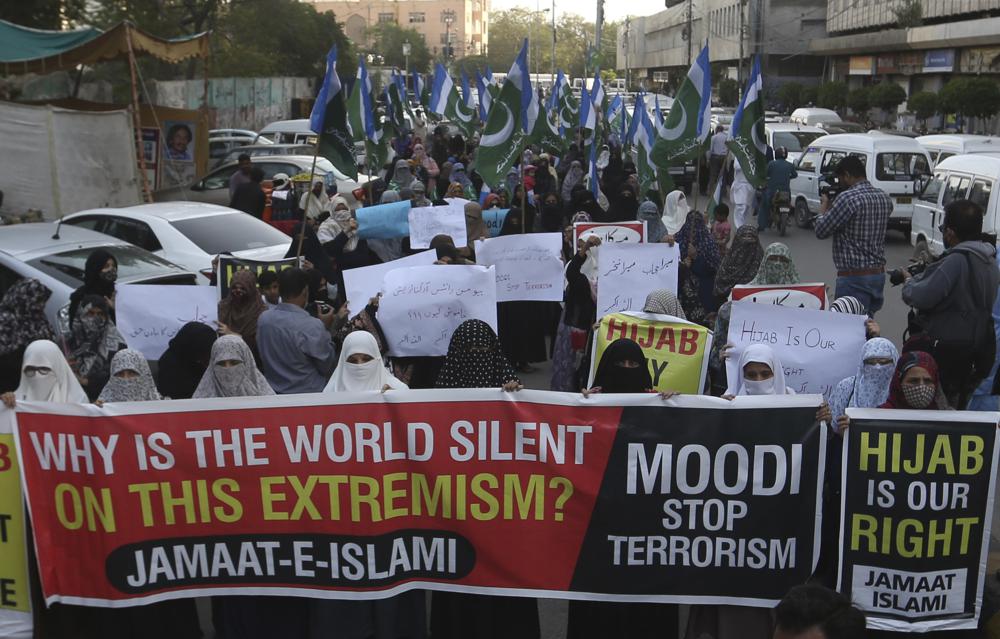 Women supporters of Jamaat-e-Islami take part in demonstration to protest against barring Muslim girls wearing hijab from attending classes at some schools in the southern Indian state of Karnataka, in Karachi, Pakistan, Thursday, Feb. 10, 2022. (AP Photo)