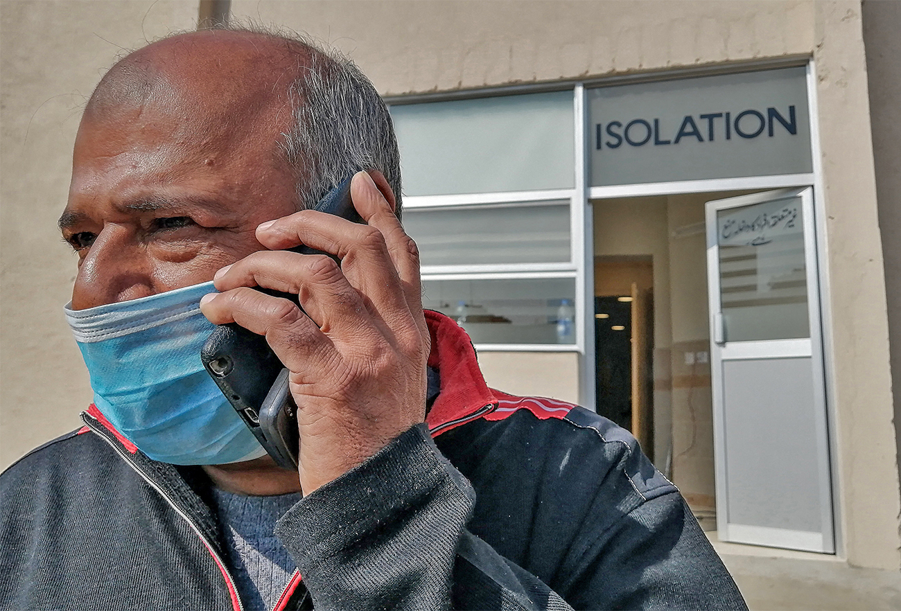 A doctor wearing a protective mask speaks on a phone as he leaves an isolation ward set up as a preventative measure following the coronavirus outbreak in Islamabad, Pakistan, on January 31, 2020. (AFP/File)