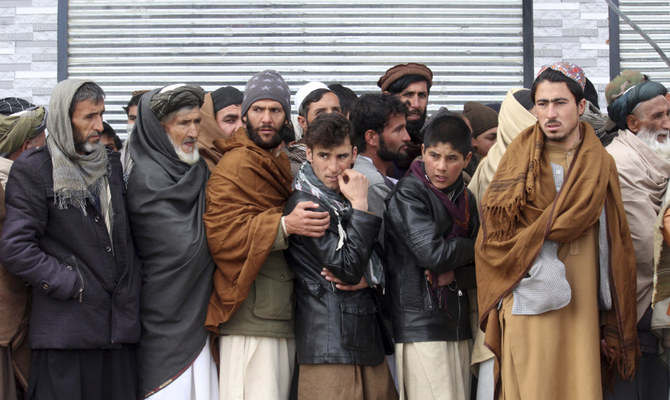 Afghans wait to receive food rations organized by the World Food Program (WFP) in Pul-e-Alam, the capital of Logar province, eastern of Afghanistan, Tuesday, Jan. 18, 2022. (AP)