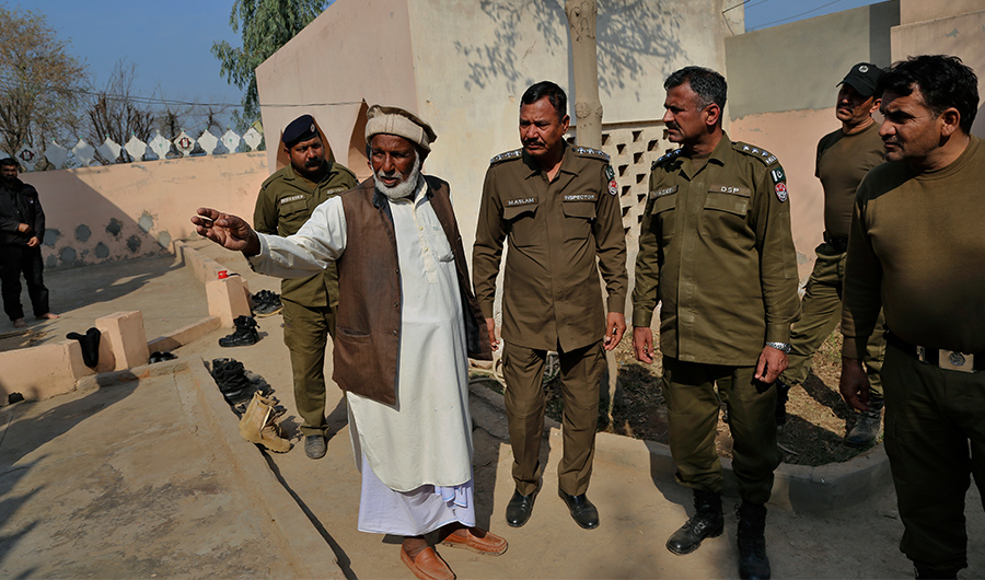 Mian Mohammad Ramzan the mosque custodian briefs police officers regarding the stoning to death of Mushtaq Ahmed by mob for alleged blasphemy in Tulamba, a remote village in the district of Khanewal, Pakistan, Feb. 13, 2022. (AP)