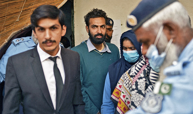 Policemen escort Zahir Jaffer (C), a Pakistani-American man who went on trial accused of raping and beheading Noor Mukadam, after his court hearing in Islamabad, Pakistan, on October 20, 2021. (AFP/File)