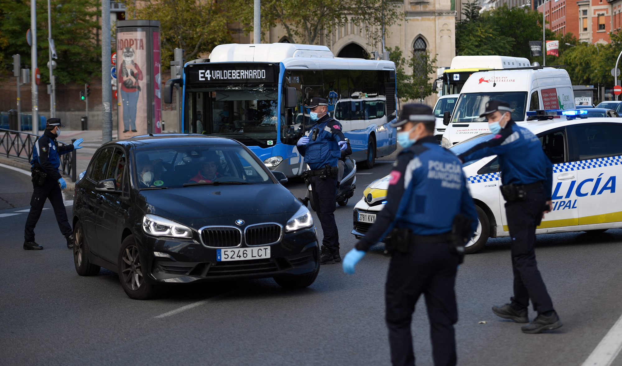 Local police officers control people's movement in a traffic checkpoint in Madrid, Spain, on October 3, 2020. (AFP/File)
