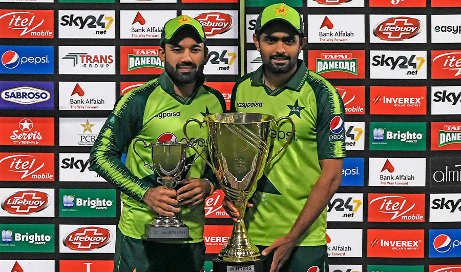 Pakistan's captain Babar Azam (R) holds the trophy with vice-captain Mohammad Rizwan after winning the T20 series against South Africa in Lahore on February 14, 2021. (AFP/FILE)