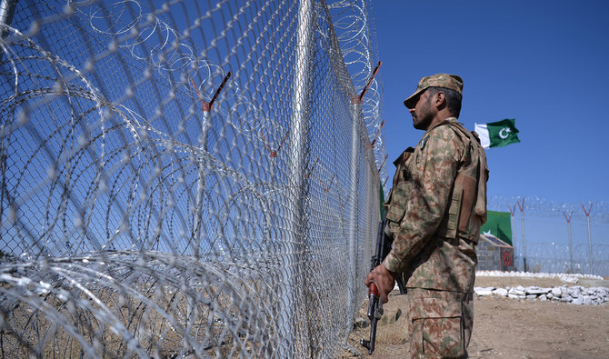 A Pakistani soldier keeps vigil next to a fenced border along with Afghan's Paktika province border in Angoor Adda in South Waziristan, Pakistan, on October 18, 2017. (AFP/File)