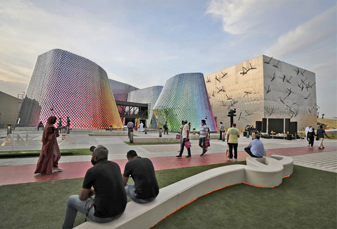 People pass by the Pakistan pavilion, left, and the Bahrain pavilions at the Dubai Expo 2020, in Dubai, United Arab Emirates, on October 3, 2021. (AP)