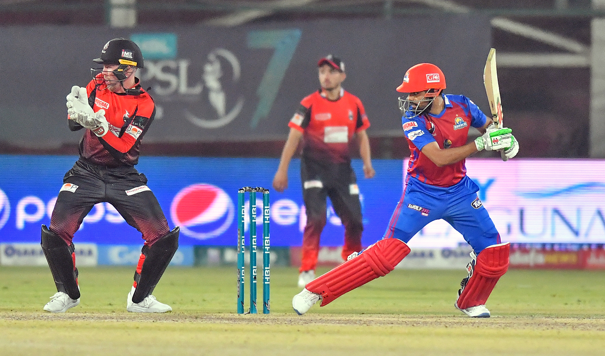 Karachi Kings' skipper Babar Azam, right, and Lahore Qalandars' Ben Dunk, left, in action during a Pakistan Super League cricket match at the National Stadium in Karachi on January 30, 2022. (Photo courtesy: Pakistan Cricket Board)