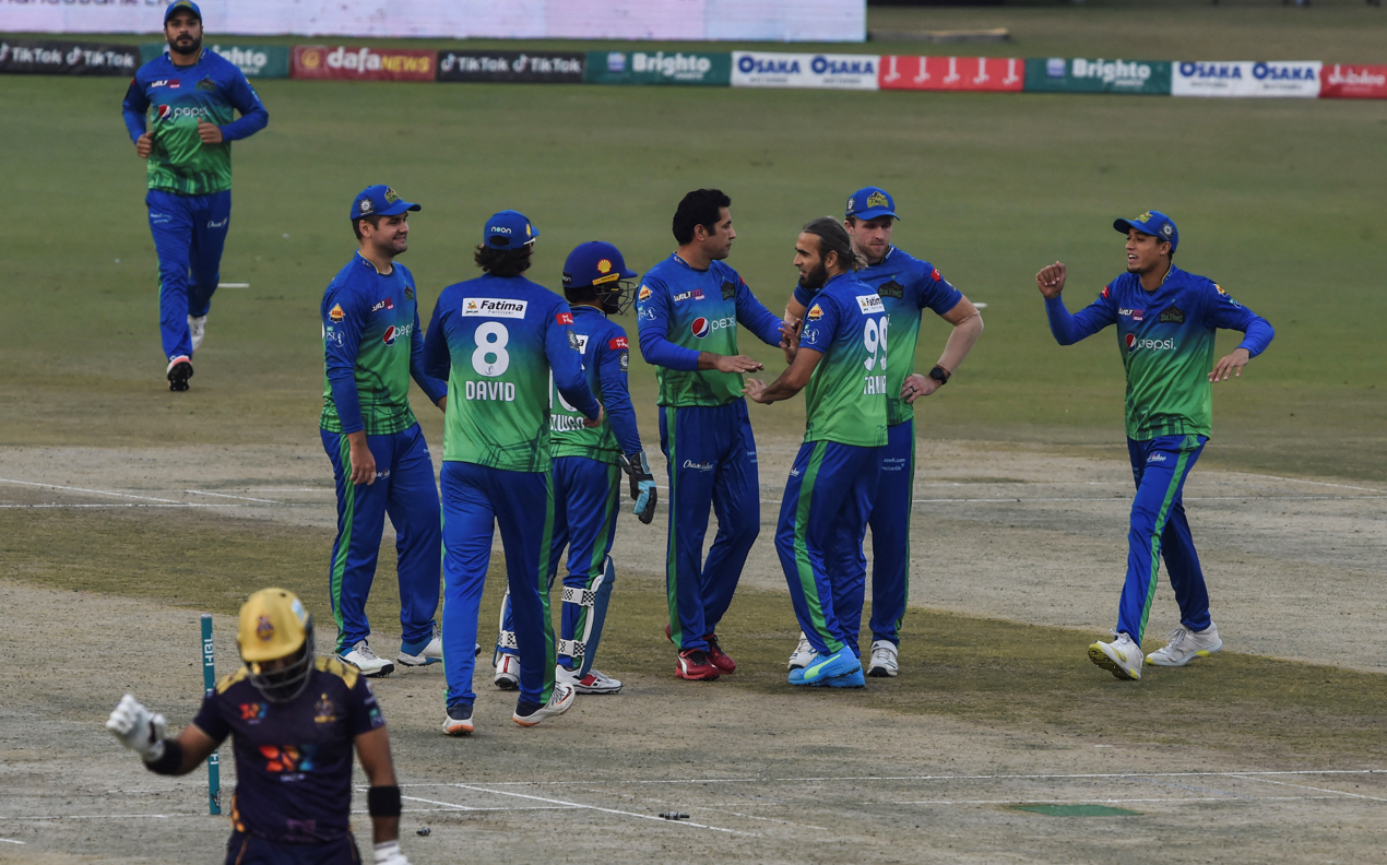 Multan Sultans' players celebrate after the dismissal of Quetta Gladiators' Iftikhar Ahmed (L) during the Pakistan Super League (PSL) Twenty20 cricket match between Multan Sultans and Quetta Gladiators at the Gaddafi Cricket Stadium in Lahore on February 18, 2022. (AFP)