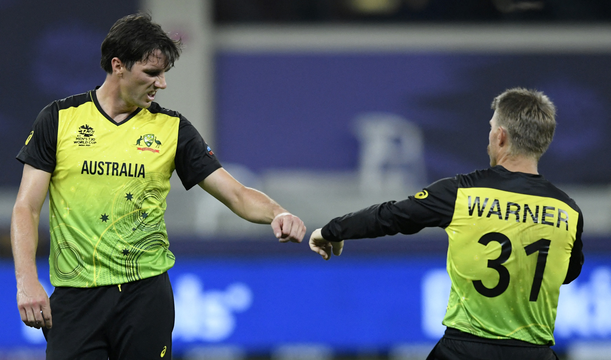 Australia's Pat Cummins, left, and David Warner celebrate wicket of Sri Lanka's captain Dasun Shanaka during the ICC men’s Twenty20 World Cup cricket match at the Dubai International Cricket Stadium on October 28, 2021. (AFP/File)