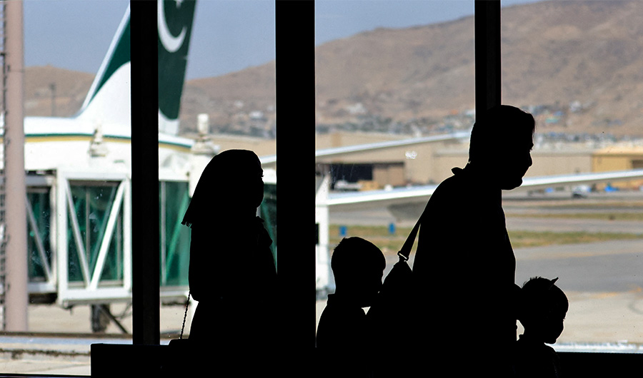 Passengers leave to board on a Pakistan International Airlines plane, which is the first international commercial flight to land since the Taliban retook power in Afghanistan on August 15, at the airport in Kabul on September 13, 2021. (AFP/FILE)