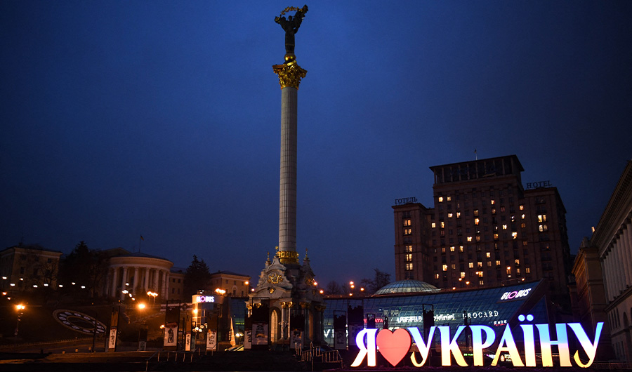 A view of the Independence Monument and a sign "I love Ukraine" in central Kyiv early on February 24, 2022. (AFP)