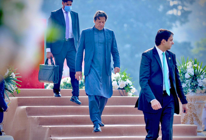 The photograph takes on December 31, 2021, shows Pakistan's Prime Minister Imran Khan (center) in Islamabad, Pakistan. (Photo courtesy: Imran Khan/Twitter)
