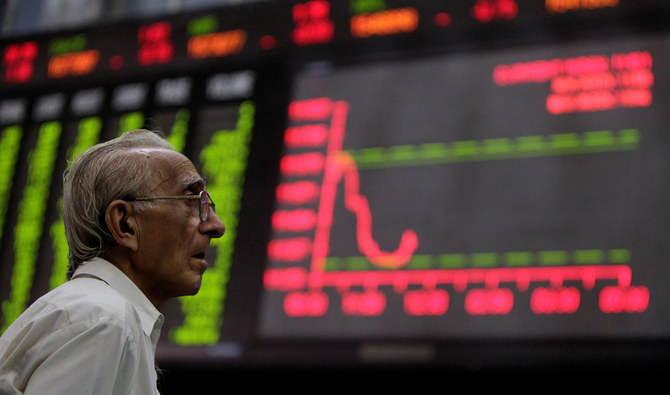 In this file photo, a man monitors an electronic board displaying stock prices at the Karachi Stock Exchange on Aug. 5, 2011. (REUTERS)