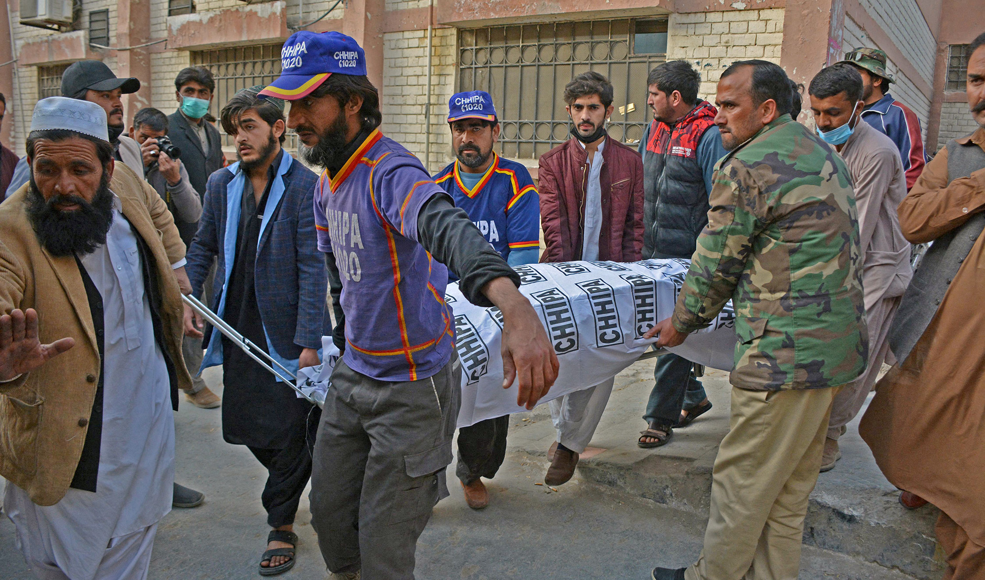 People transfer the body of a slain policeman who died in a gun attack, from an hospital in Quetta, Pakistan, on February 25, 2022. (AFP)