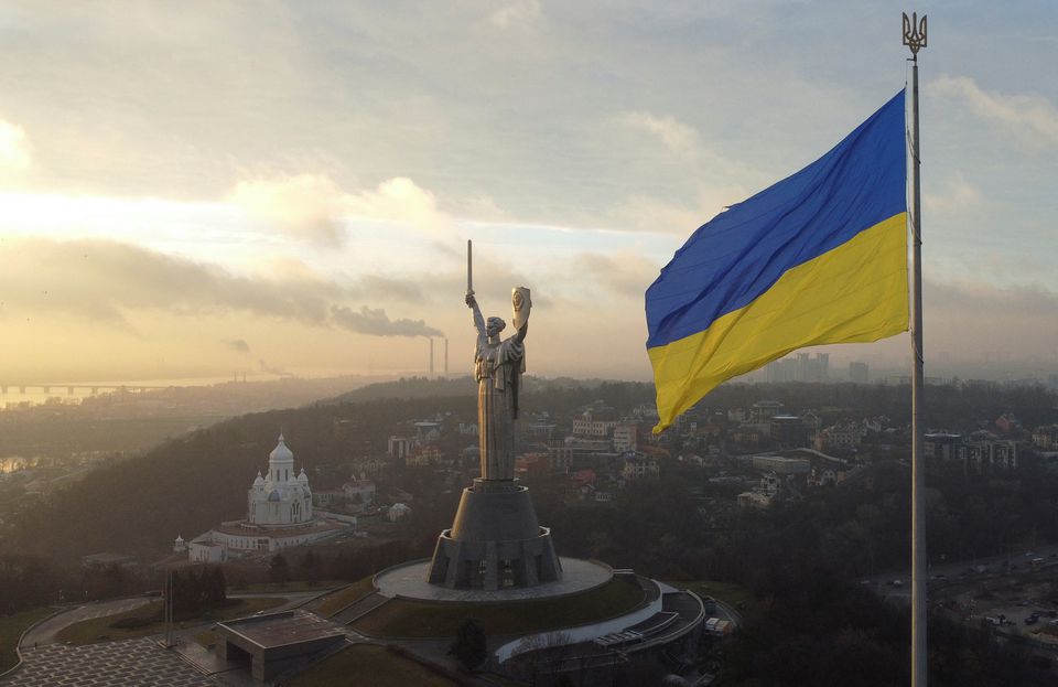 Ukraine's biggest national flag on the country's highest flagpole and the giant 'Motherland' monument are seen at a compound of the World War II museum in Kyiv, Ukraine, December 16, 2021. (REUTERS)
