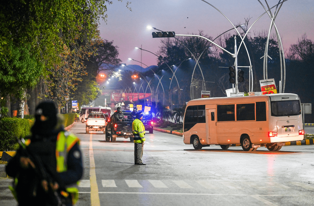 Security personnel escort a convoy carrying Australian cricketers and team officials upon their arrival in Islamabad on February 27, 2022, on their first tour of the country in nearly a quarter of a century. (AFP)