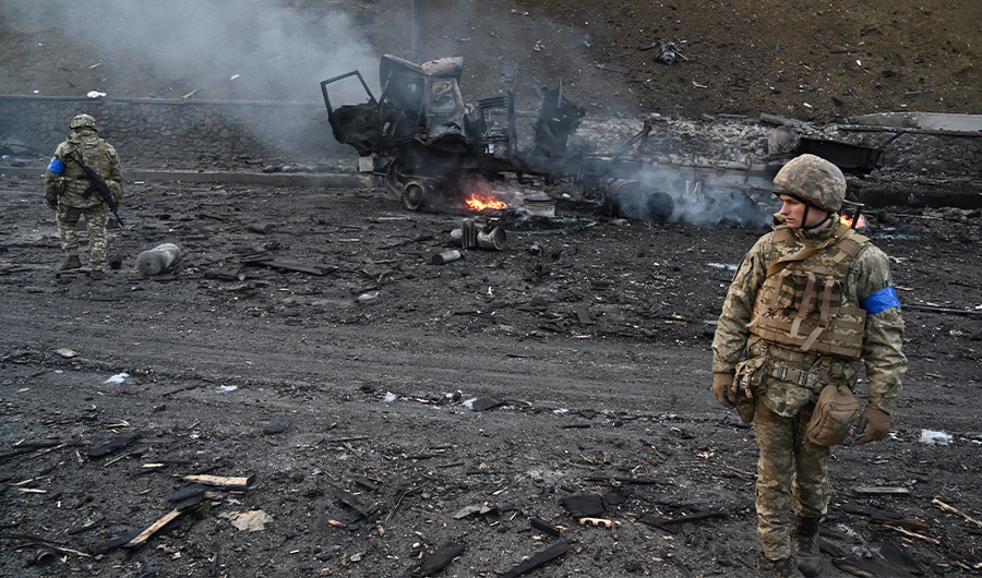 Ukrainian service members look for unexploded shells after a fighting with Russian raiding group in the Ukrainian capital of Kyiv in the morning of February 26, 2022. (AFP)